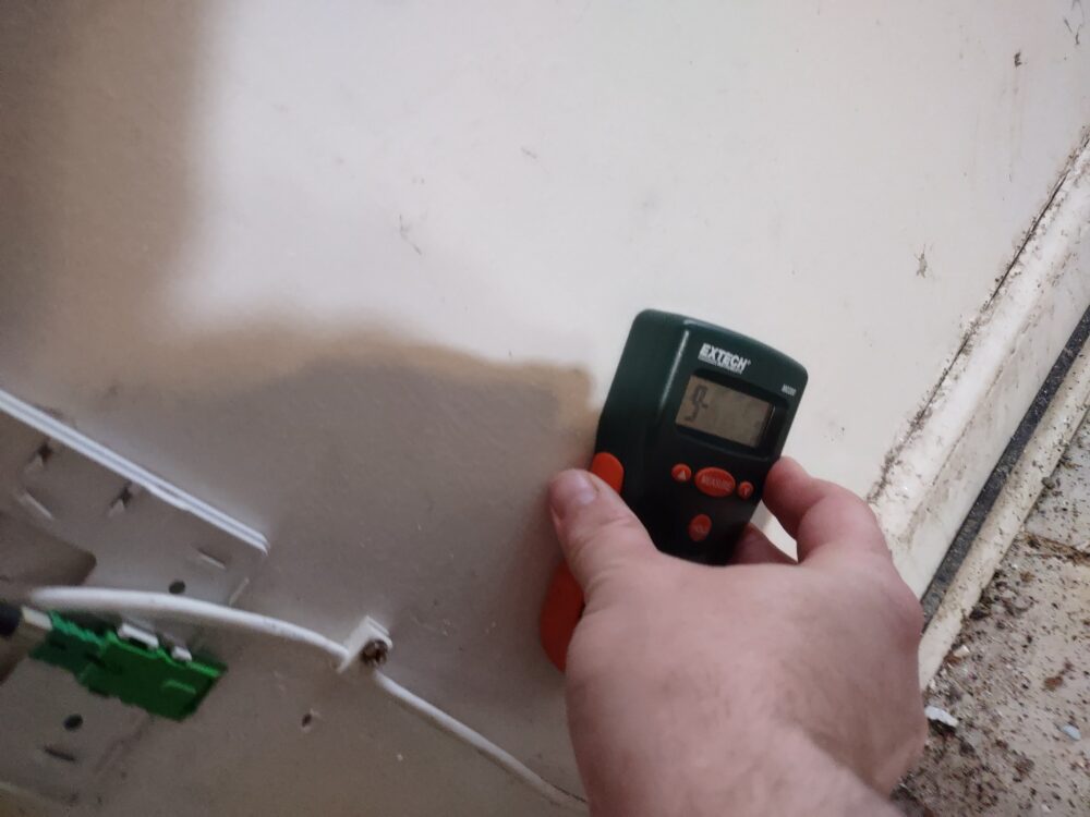 Newly remediated crawl space showing clean foundation, installed vapor barrier, dehumidifier, and proper ventilation in Marietta home.