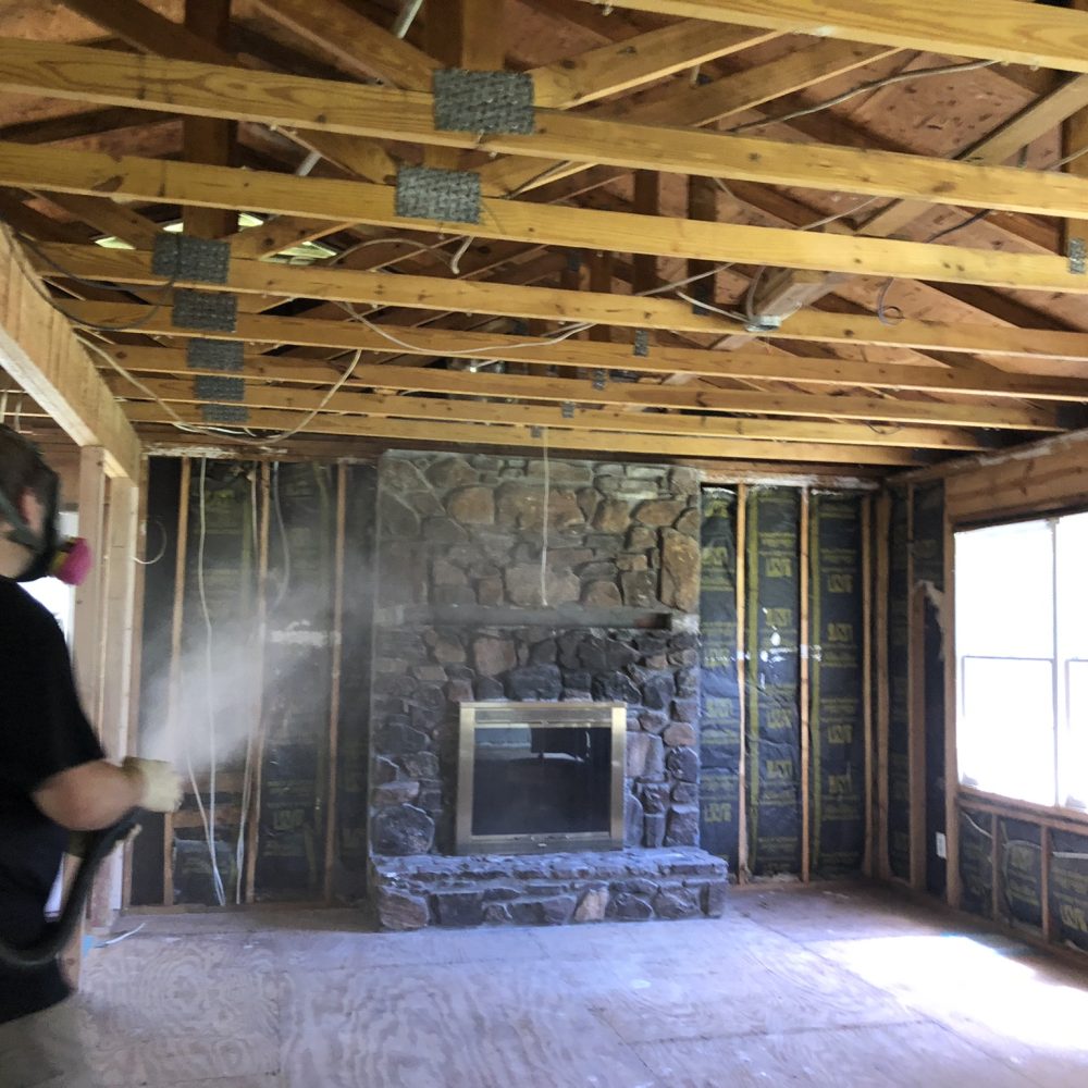 Licensed pest control technician conducting rodent waste removal in Marietta GA home